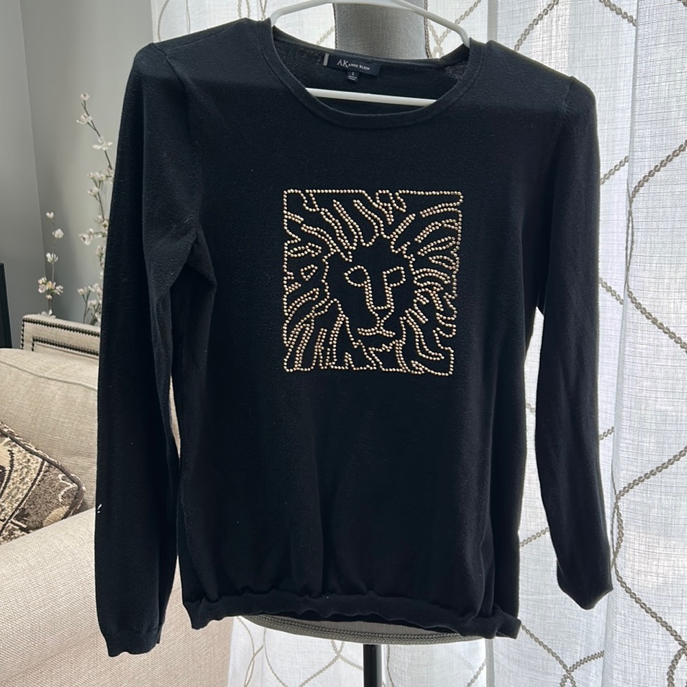 Solid black long sleeve shirt with gold lion design
